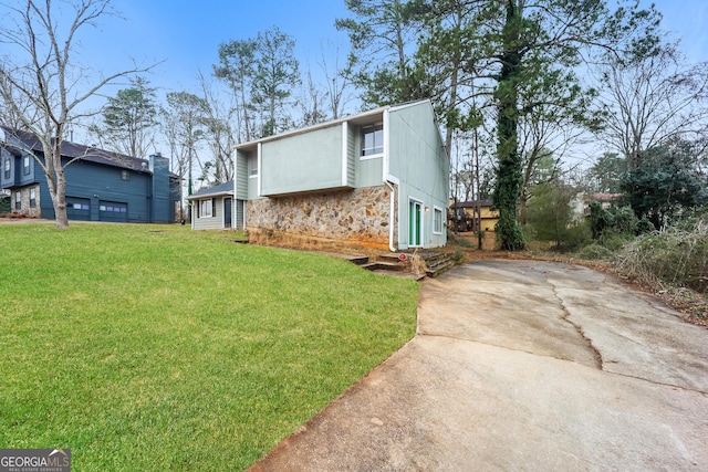 view of side of home with a yard