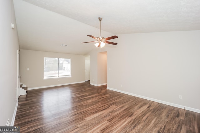 spare room with dark wood-type flooring, ceiling fan, and vaulted ceiling