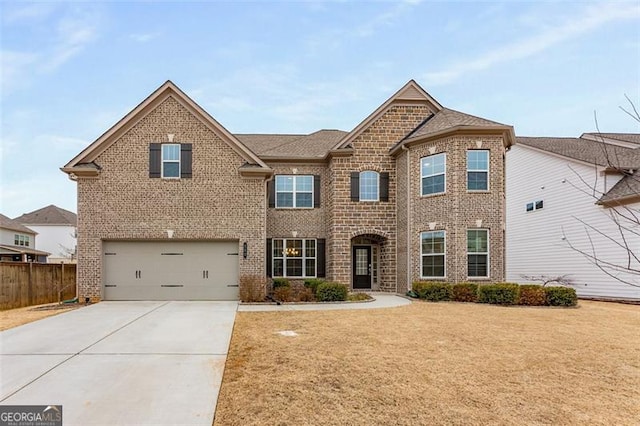 view of front of home featuring a garage and a front yard