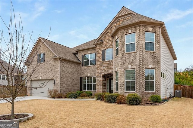 view of front facade featuring central AC, a garage, and a front lawn