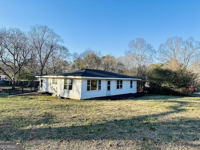 view of side of home with a yard