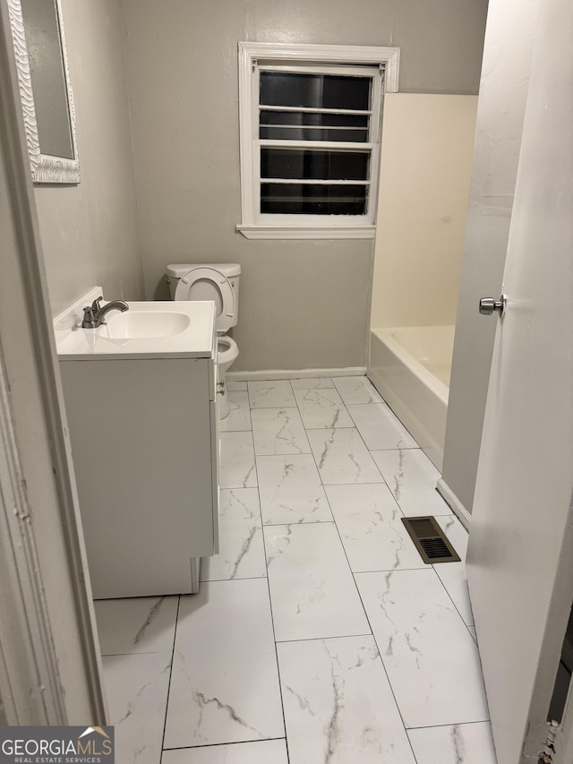 bathroom featuring vanity and toilet