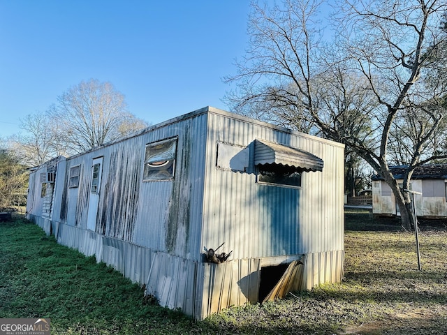 view of outbuilding featuring a lawn