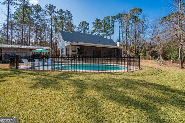 view of swimming pool featuring a lawn and a sunroom