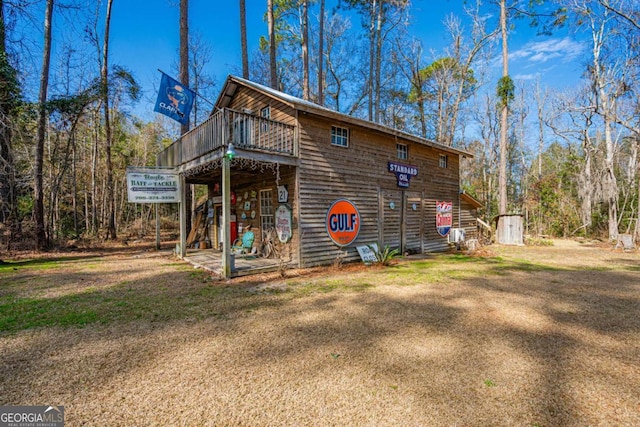 view of home's exterior featuring a storage shed and a lawn