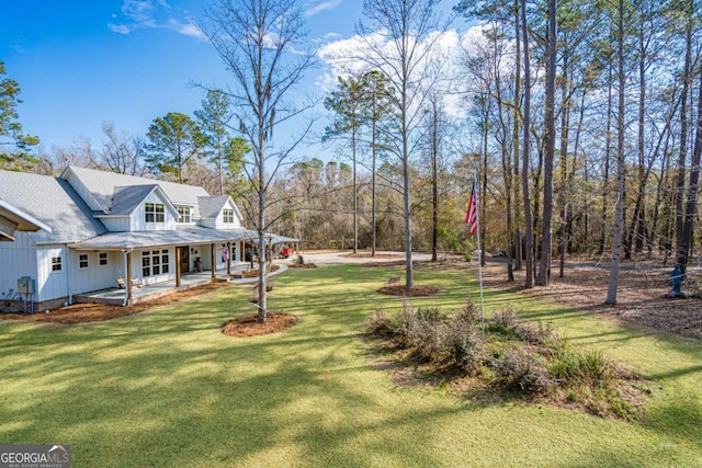 view of yard with covered porch