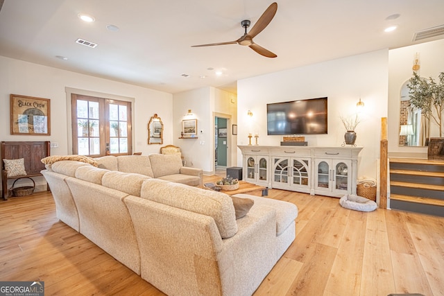 living room featuring french doors, ceiling fan, and light hardwood / wood-style floors