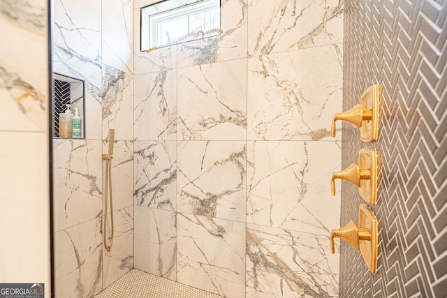 bathroom with a tile shower