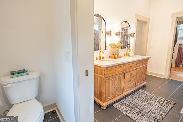 bathroom with vanity, tile patterned floors, and toilet