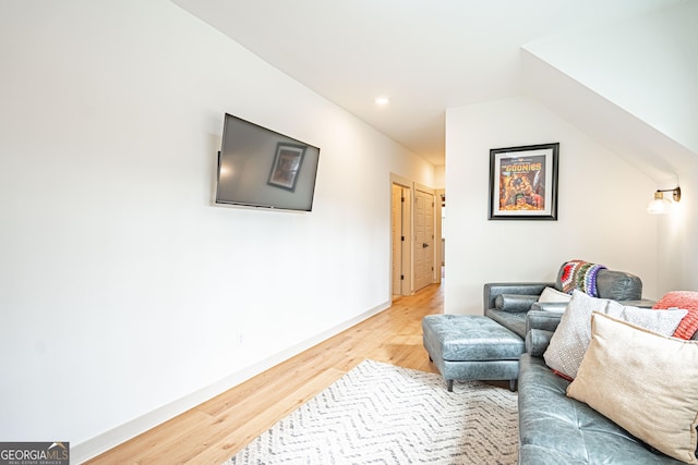 sitting room featuring lofted ceiling and light hardwood / wood-style floors