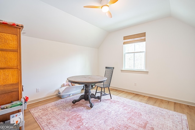 dining space with ceiling fan, lofted ceiling, and wood-type flooring