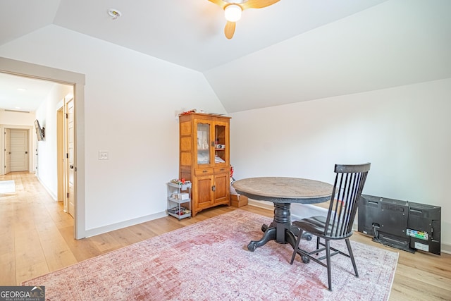 dining room featuring lofted ceiling, ceiling fan, and light wood-type flooring