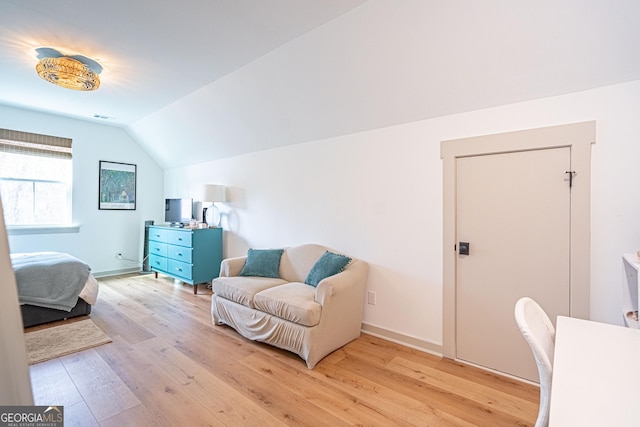 bedroom featuring vaulted ceiling and light hardwood / wood-style floors