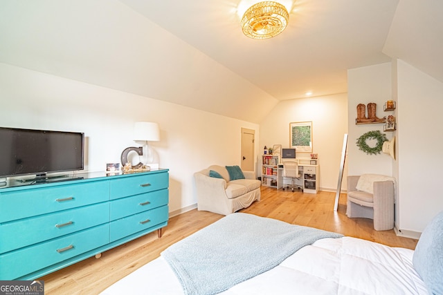 bedroom featuring light hardwood / wood-style flooring and vaulted ceiling