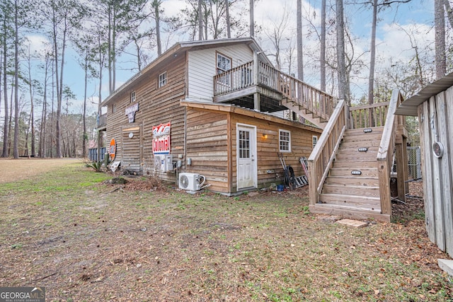 exterior space with a wooden deck and ac unit