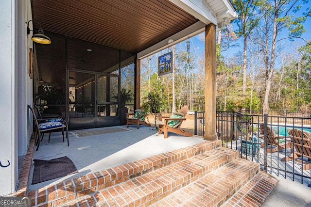 view of patio with a fenced in pool