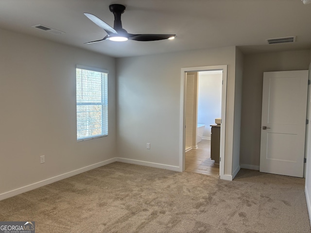 carpeted empty room featuring ceiling fan