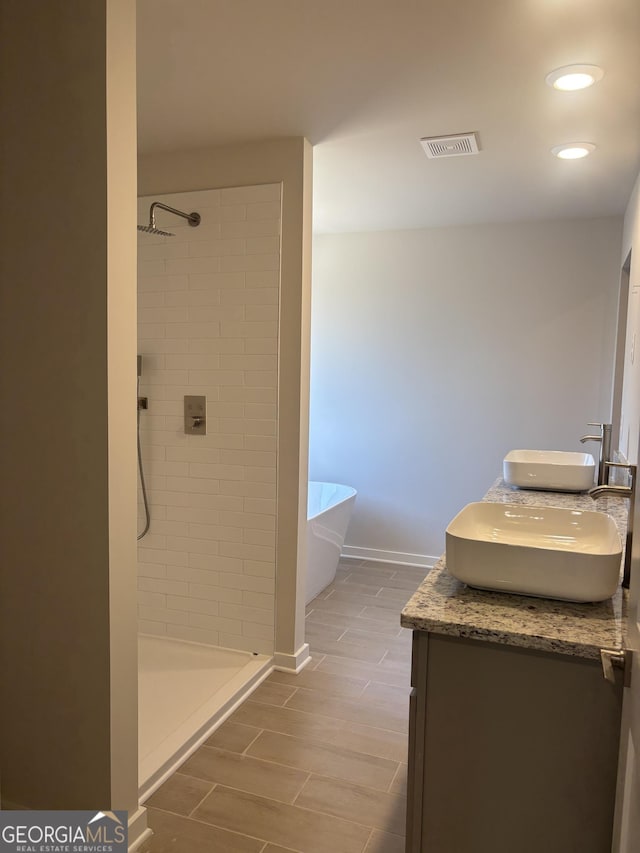 bathroom with vanity and independent shower and bath