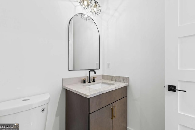 bathroom featuring vanity and toilet