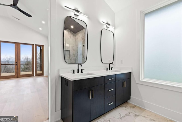 bathroom featuring vaulted ceiling, vanity, ceiling fan, and french doors