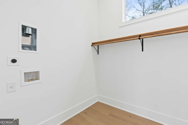 clothes washing area featuring electric dryer hookup, washer hookup, and hardwood / wood-style flooring