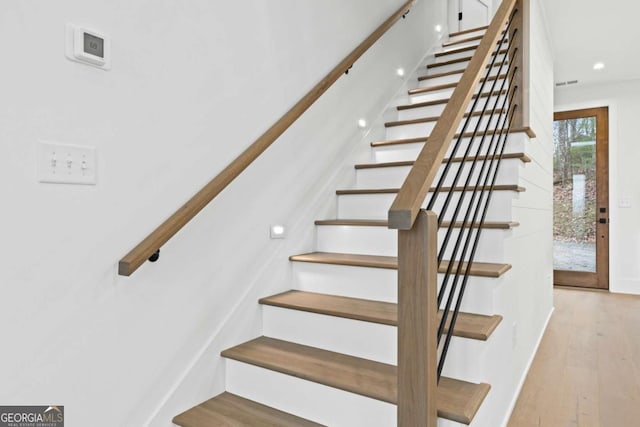 staircase with wood-type flooring