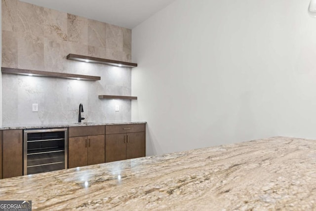 kitchen featuring beverage cooler and sink