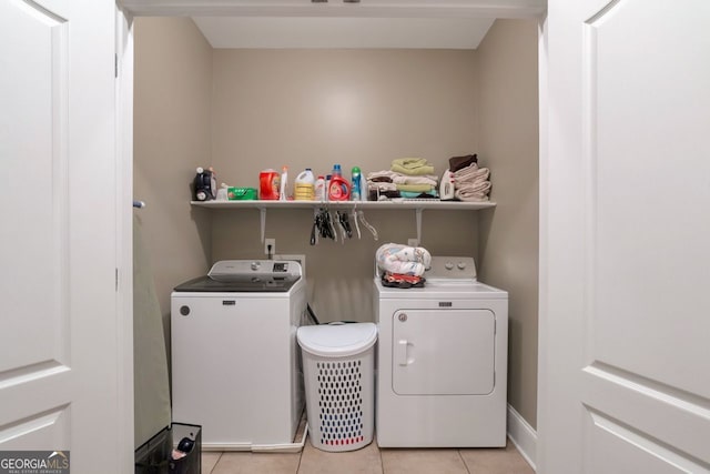 laundry room with light tile patterned floors and independent washer and dryer