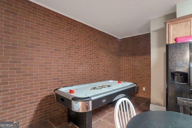 recreation room with dark tile patterned flooring