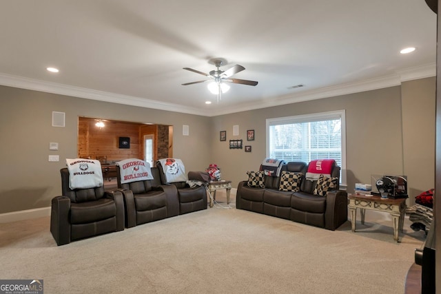 home theater room with light carpet, crown molding, and ceiling fan