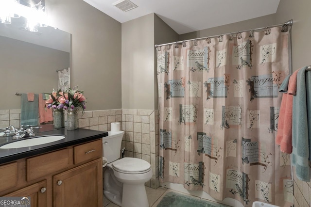 bathroom featuring tile walls, vanity, a shower with curtain, tile patterned floors, and toilet