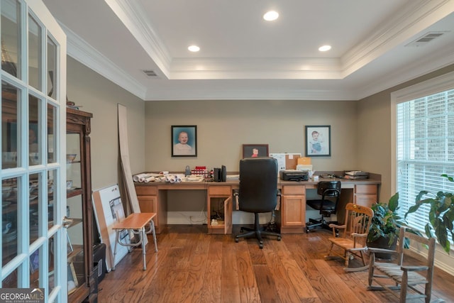 office with crown molding, a tray ceiling, and wood-type flooring