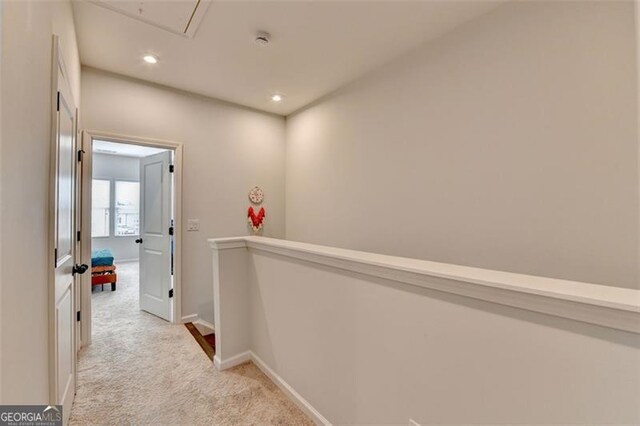 hallway with light colored carpet