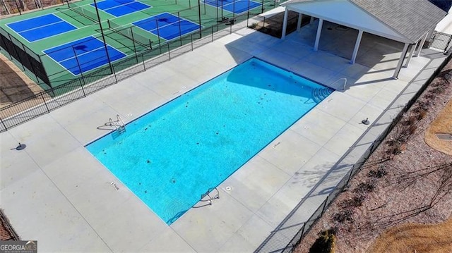 view of pool featuring tennis court