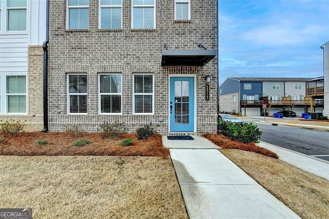 entrance to property featuring a lawn