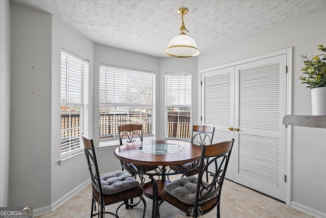 dining space featuring a textured ceiling