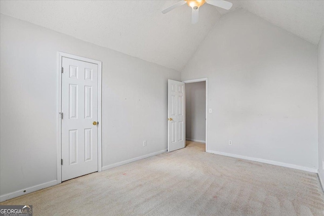 unfurnished bedroom featuring light carpet, ceiling fan, high vaulted ceiling, and a textured ceiling