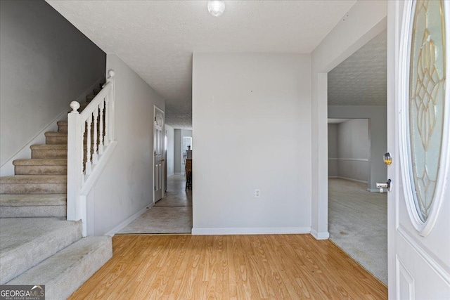 entrance foyer featuring hardwood / wood-style flooring and a textured ceiling