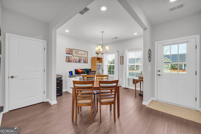 dining space with an inviting chandelier and dark hardwood / wood-style floors