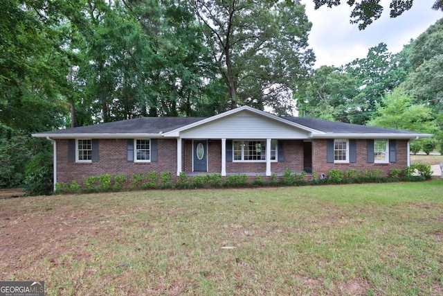 single story home with a porch and a front lawn