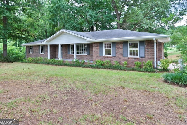 ranch-style house with a porch and a front yard