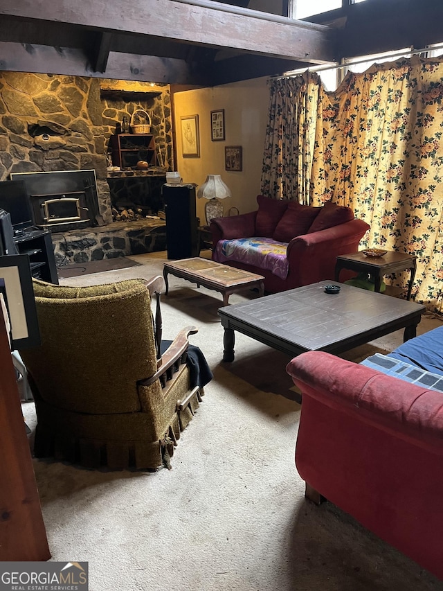 living room featuring a fireplace, carpet floors, and beamed ceiling