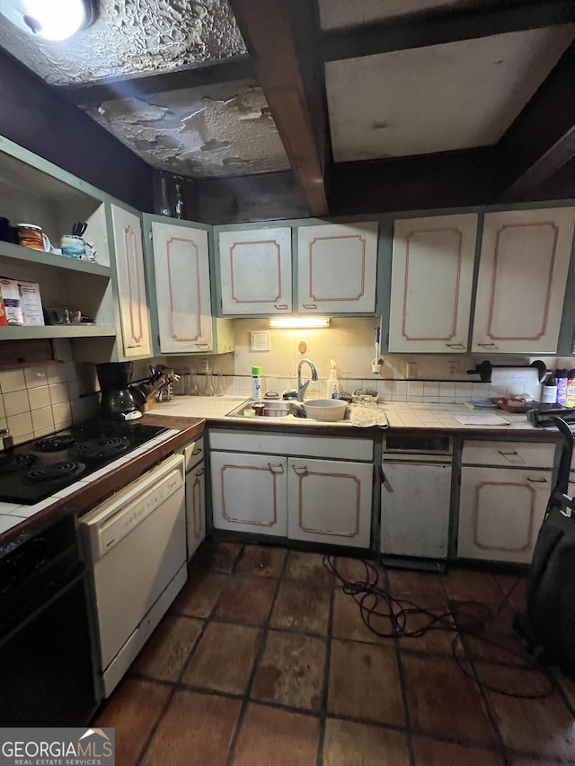 kitchen with sink, dishwasher, backsplash, wall oven, and white cabinets