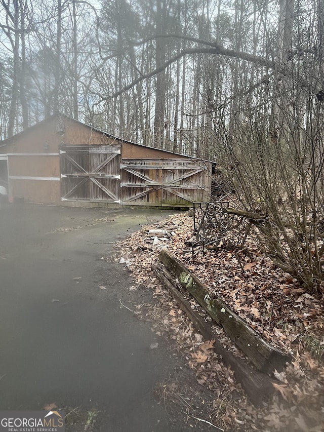 view of side of home featuring an outbuilding