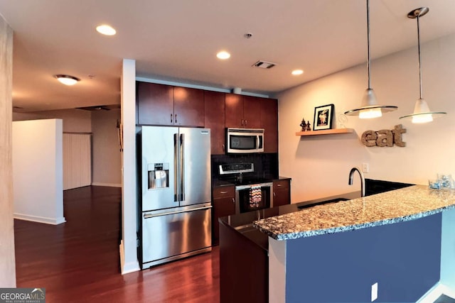 400 W Peachtree St NW Unit 3216, Atlanta, GA 30308 - kitchen with tasteful backsplash, dark wood-type flooring, a peninsula, stainless steel appliances, and pendant lighting