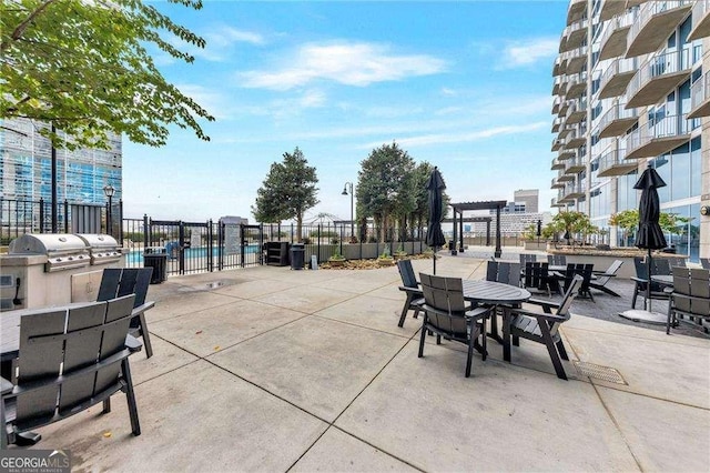 400 W Peachtree St NW Unit 3216, Atlanta, GA 30308 - view of patio featuring area for grilling, fence, and a pergola