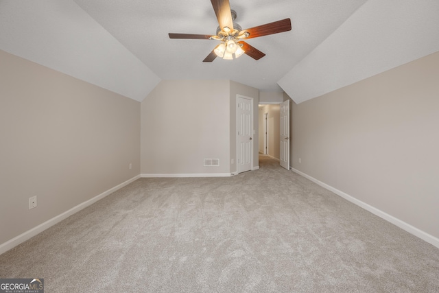 bonus room with lofted ceiling, light colored carpet, and ceiling fan