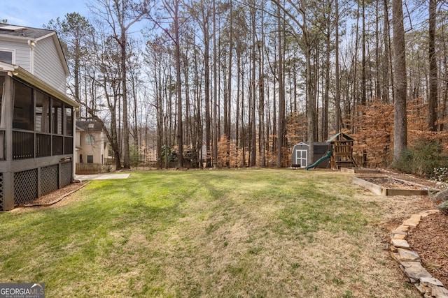 view of yard with a playground and a sunroom