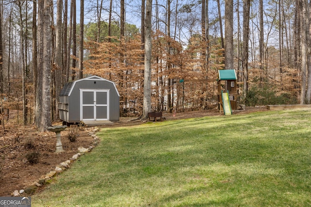 view of yard featuring a playground and a shed