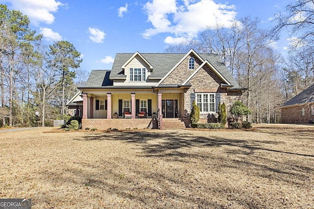 view of front facade with a front yard and covered porch